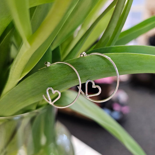 SILVER HOOP STUDS WITH HIDDEN HEARTS